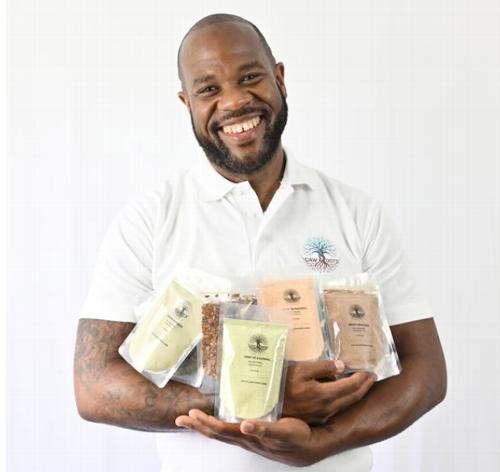 Christopher holding caw roots products